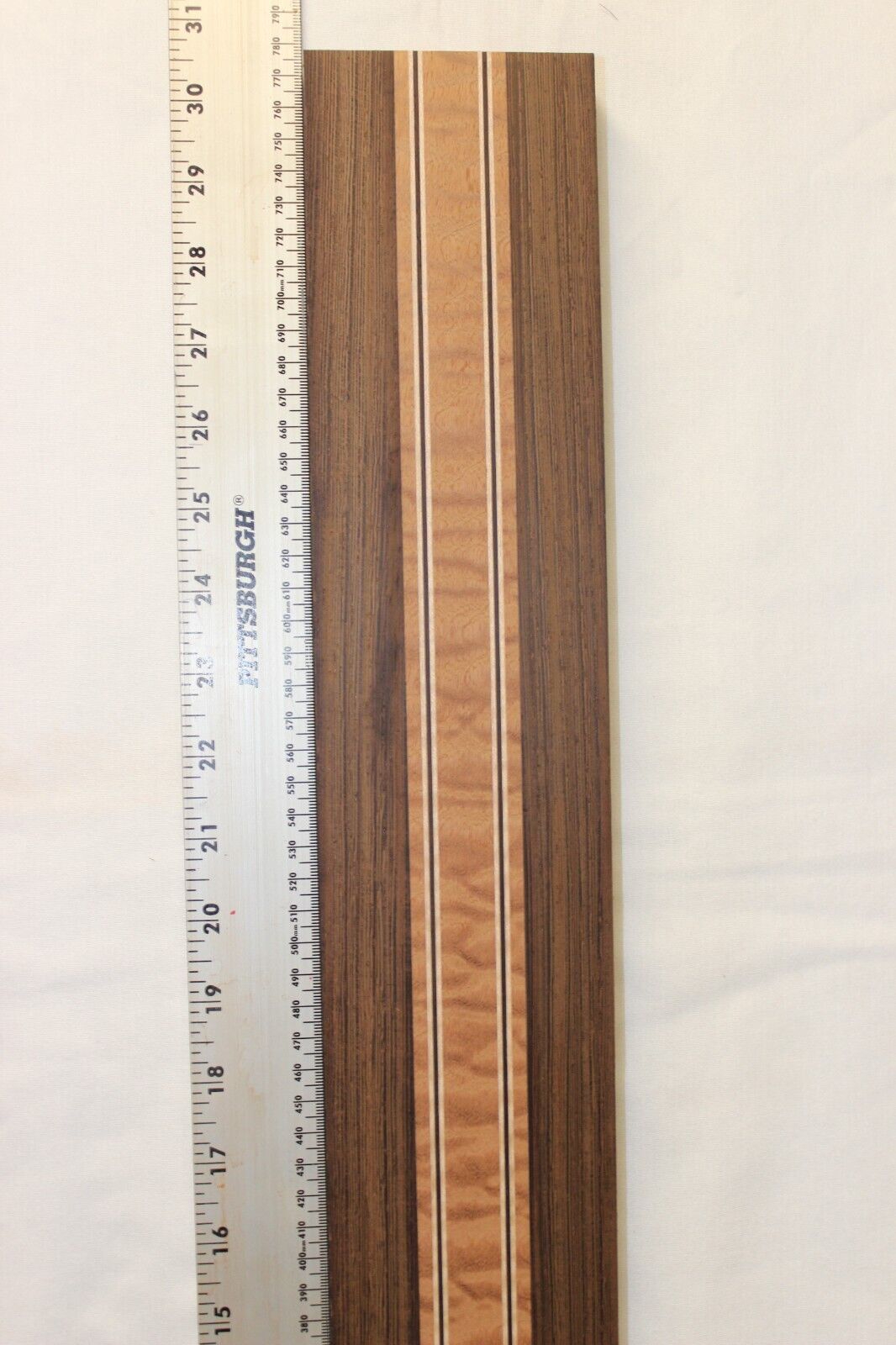 Quilted sapele, wenge and flame maple laminated guitar neck blank.