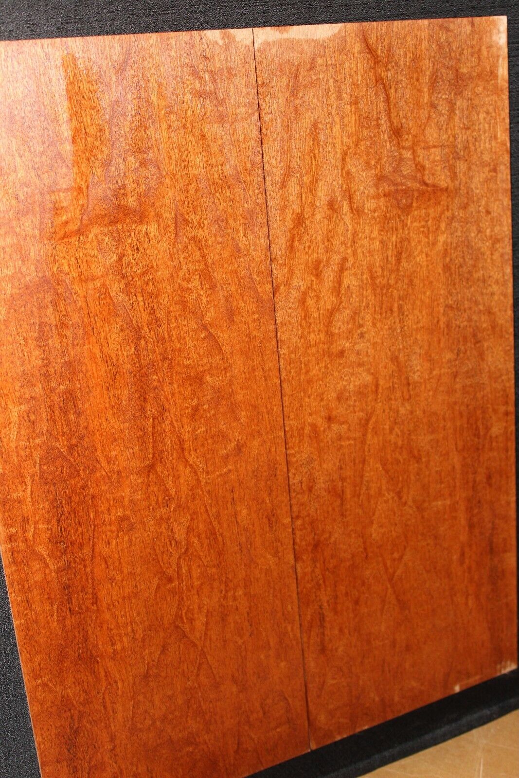 Figured genuine mahogany bookmatched electric guitar drop top.