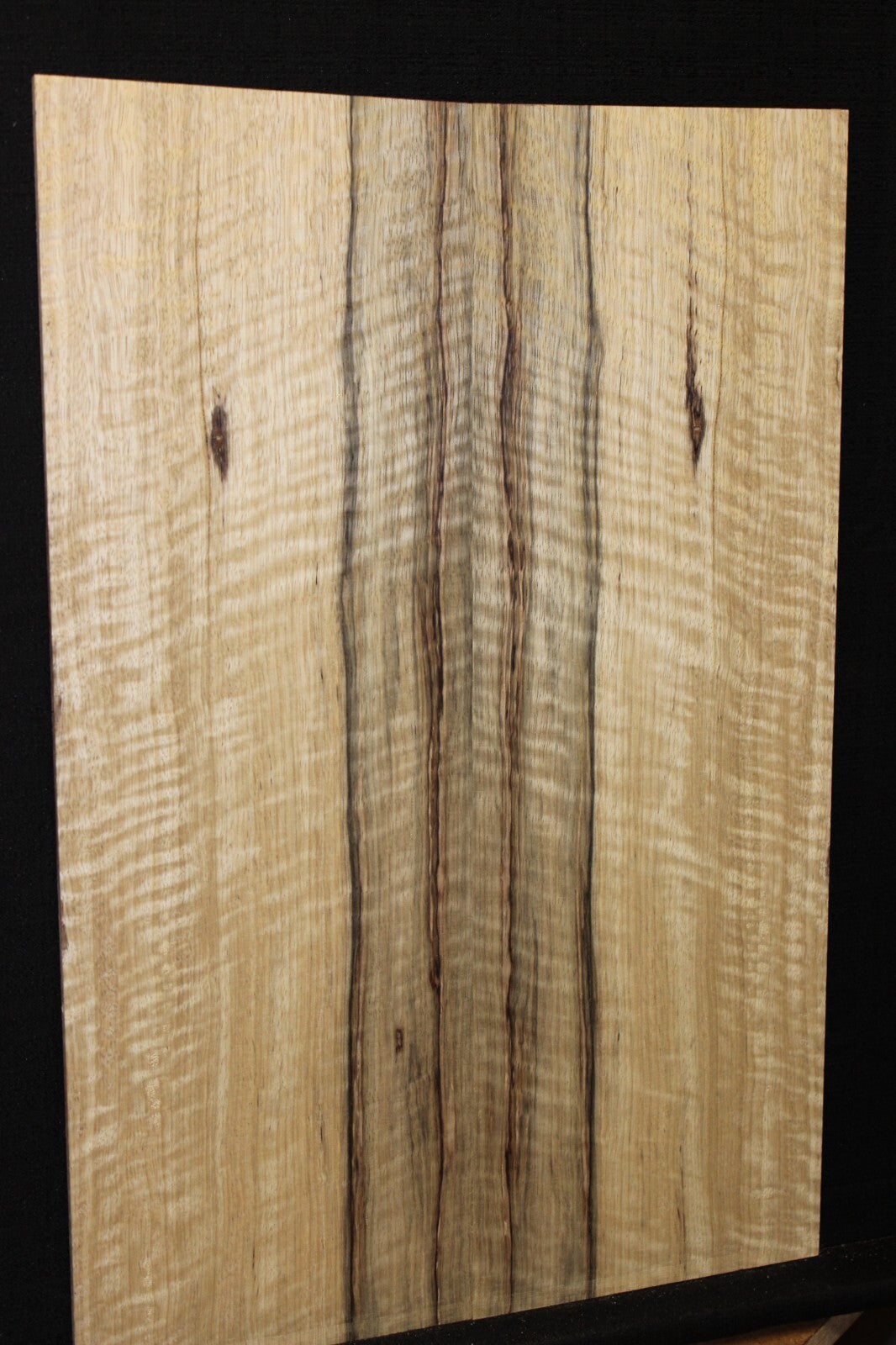 Curly black limba / korina figured book matched guitar top.