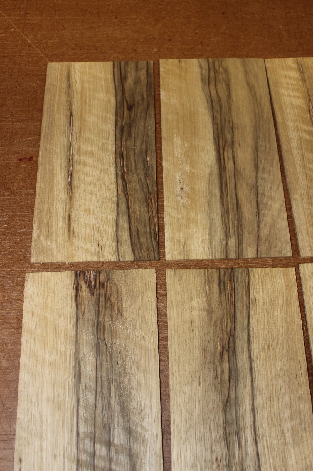 Quarter sawn, figured black limba headstock / peg head veneer. Sold individually