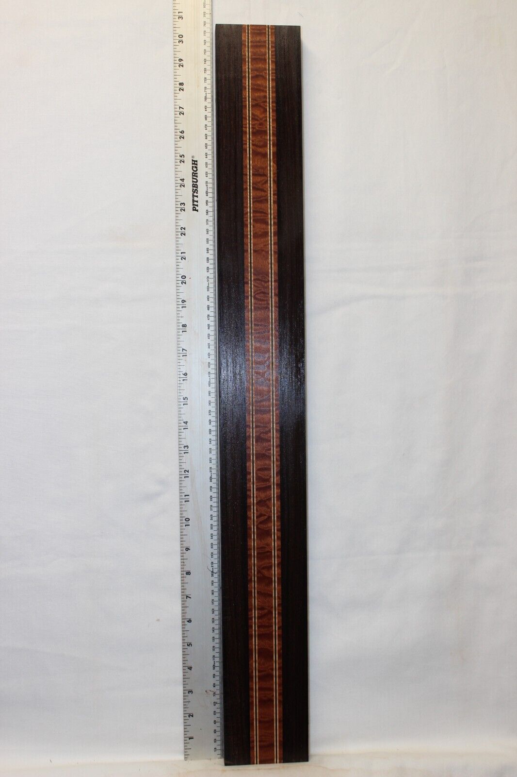 Quilted sapele, wenge and flame maple laminated guitar neck blank.