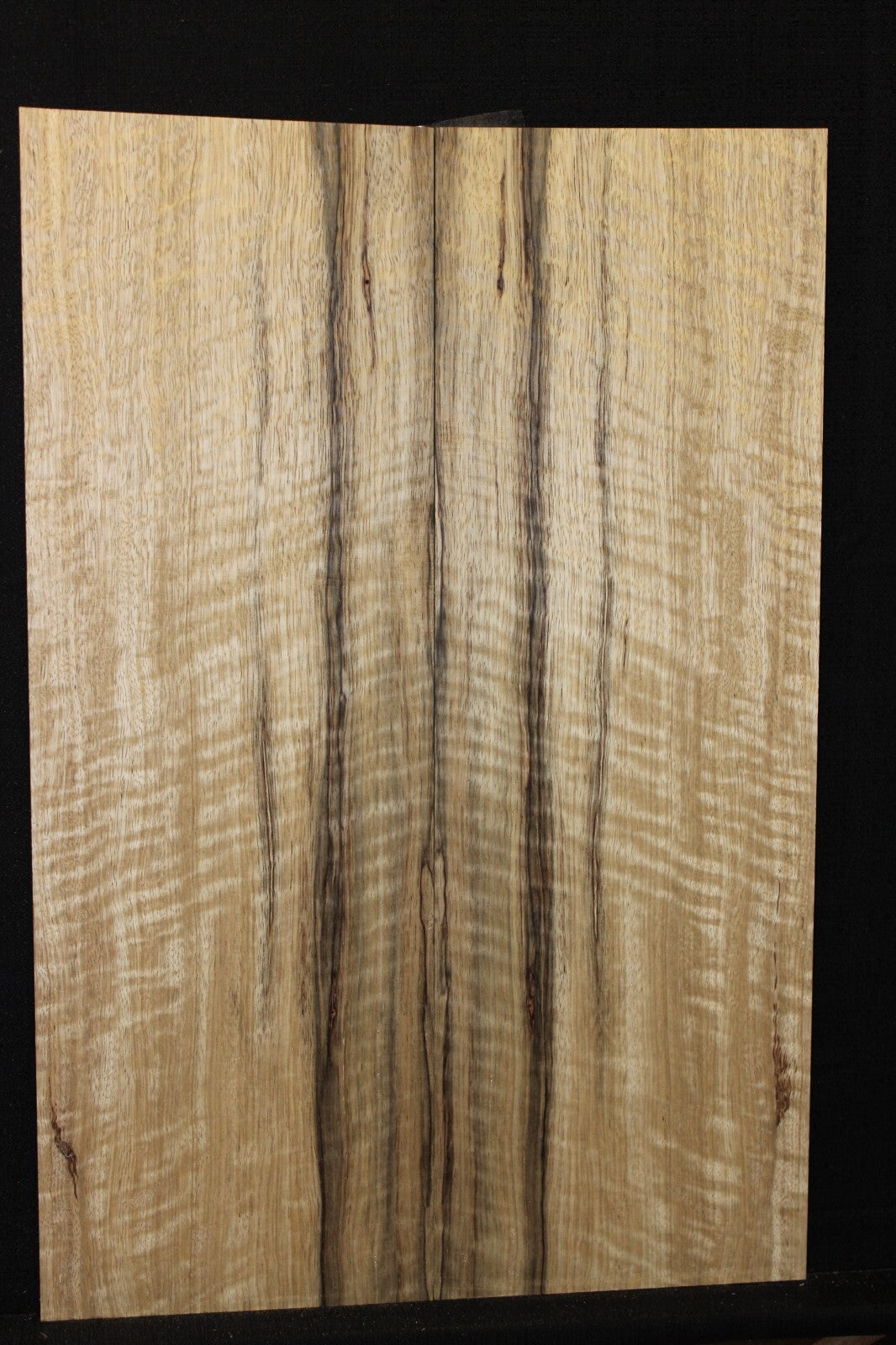 Curly black limba / korina figured book matched guitar top.