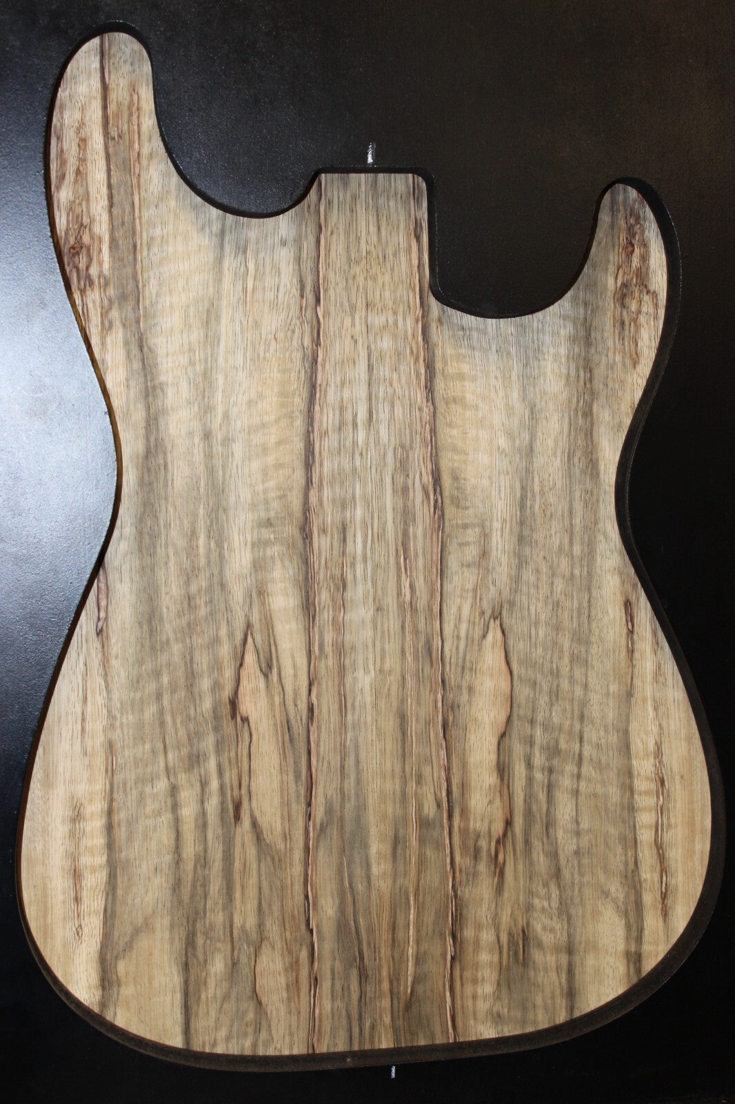 Curly black limba / korina figured book matched guitar top.