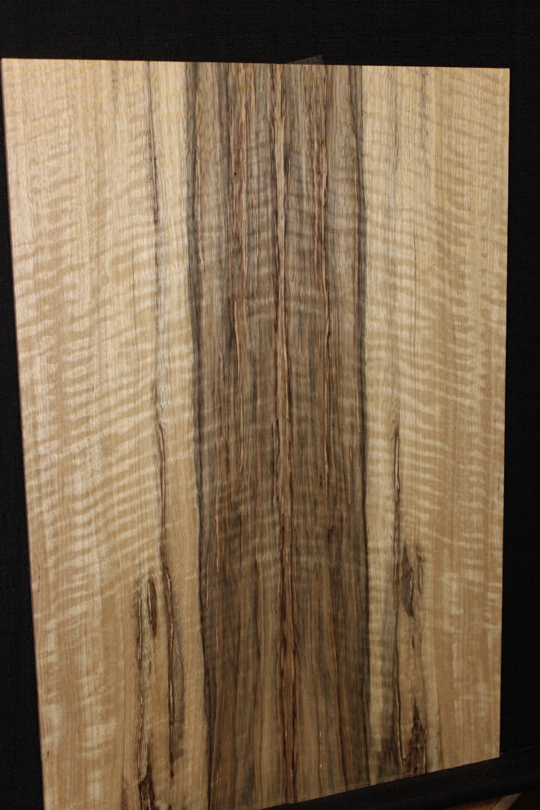 Curly black limba / korina figured book matched guitar top.