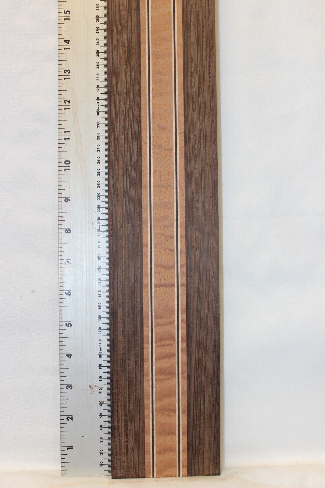 Quilted sapele, wenge and flame maple laminated guitar neck blank.