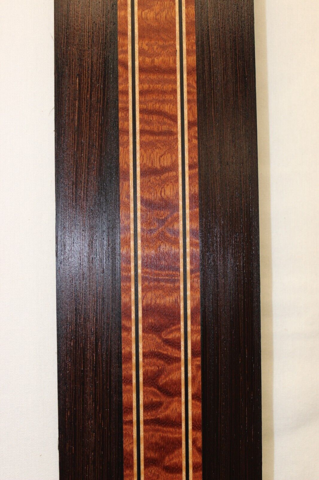 Quilted sapele, wenge and flame maple laminated guitar neck blank.