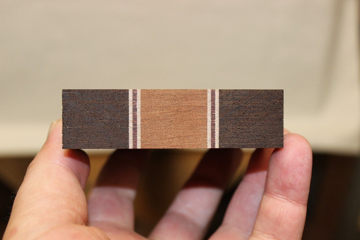 Quilted sapele, wenge, hard maple and purple-heart laminated guitar neck blank.