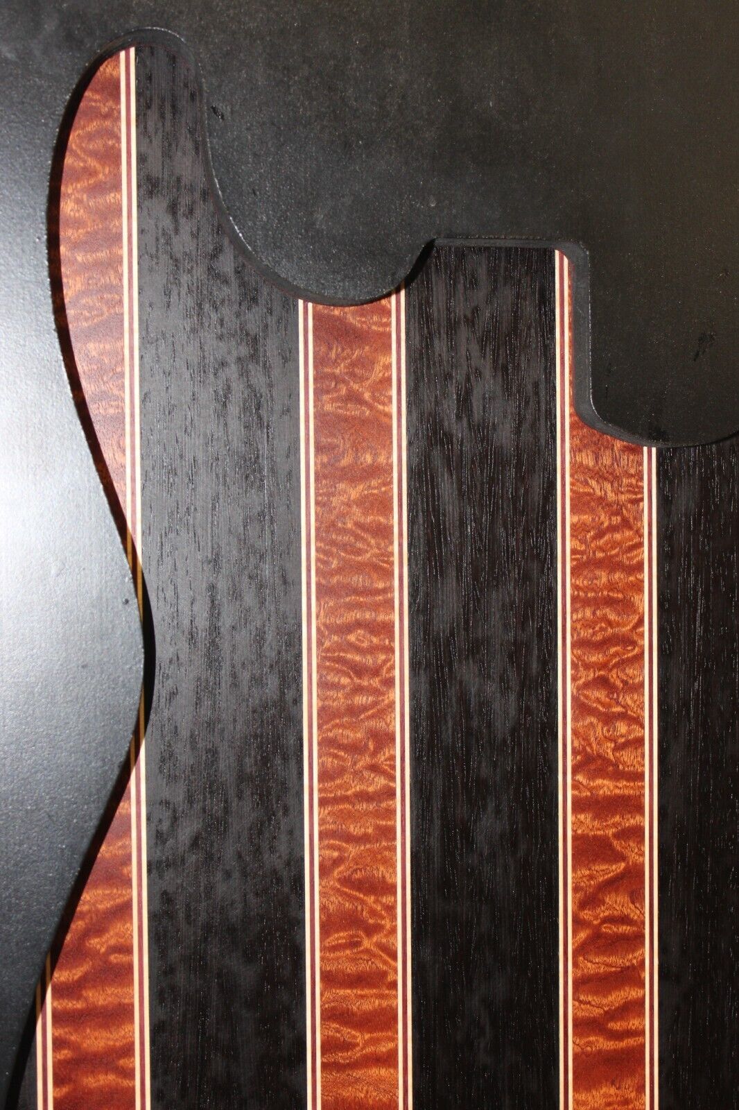Quilted sapele, wenge, maple and purple-heart laminated electric guitar top.