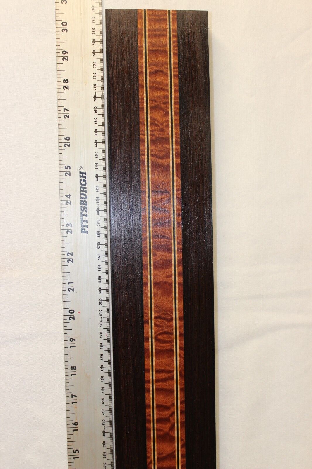 Quilted sapele, wenge and flame maple laminated guitar neck blank.