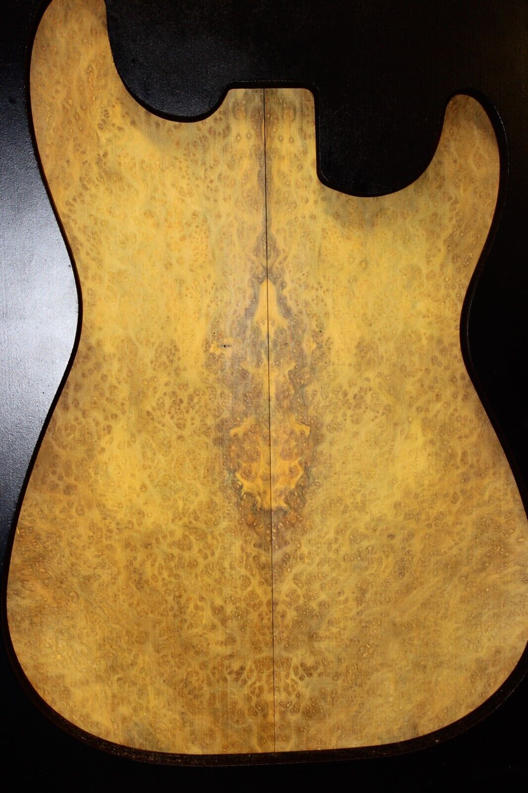 Golden Amboyna burl book matched guitar top.