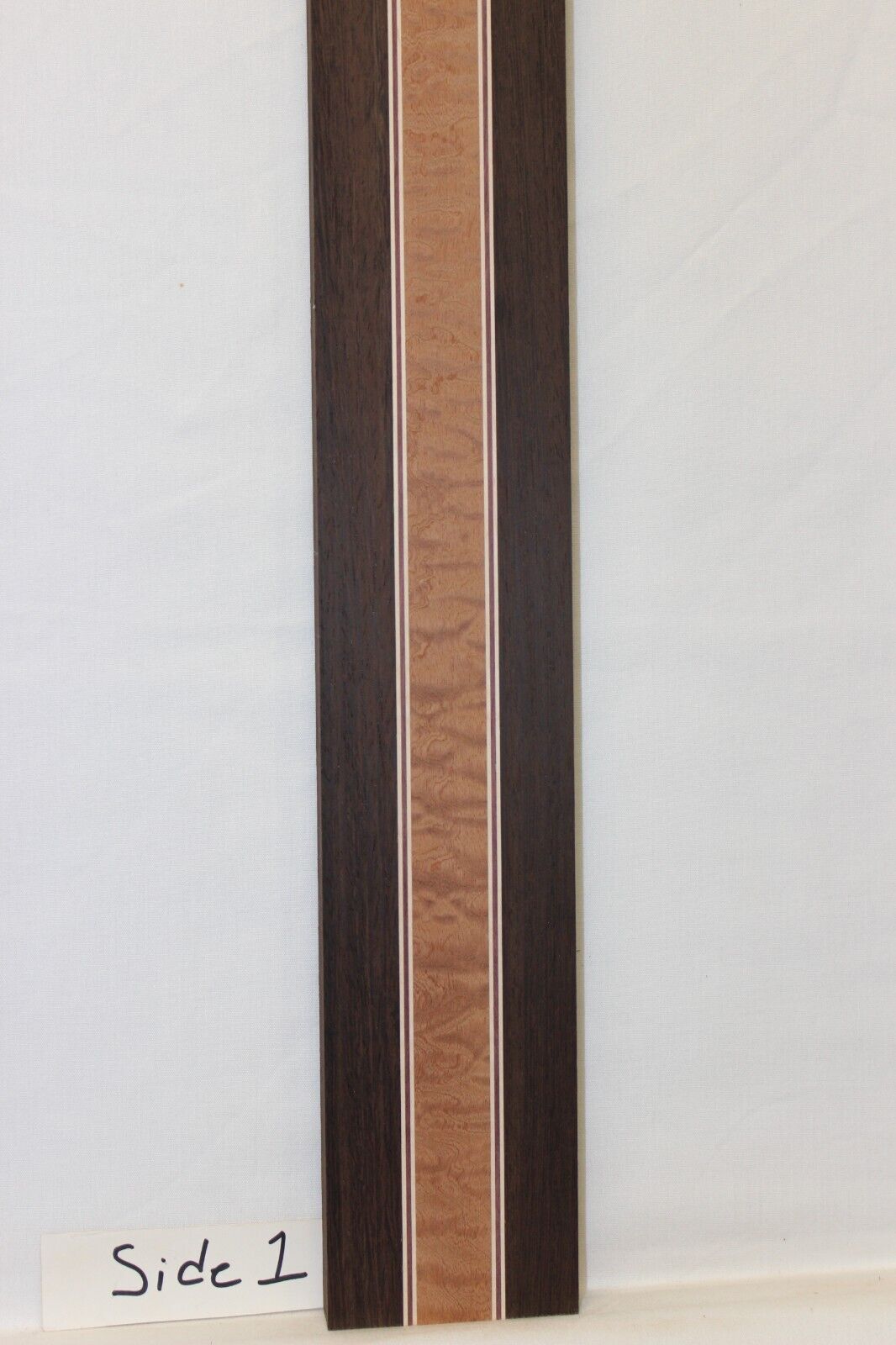Quilted sapele, wenge, hard maple and purple-heart laminated guitar neck blank.