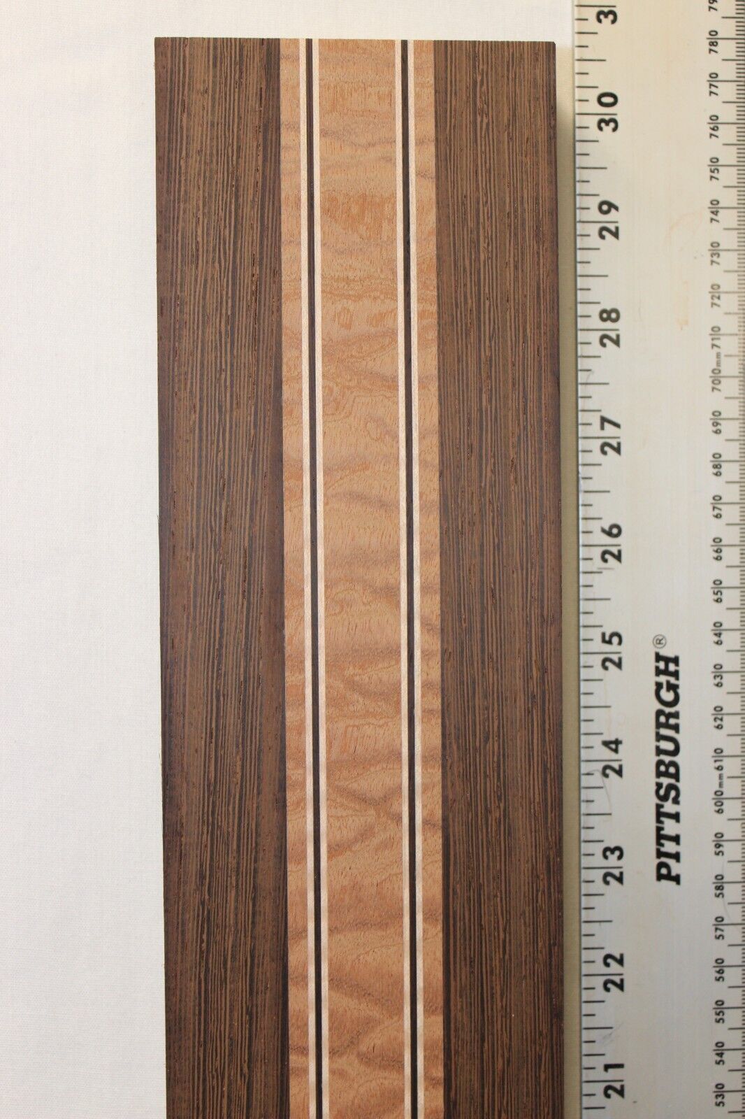 Quilted sapele, wenge and flame maple laminated guitar neck blank.