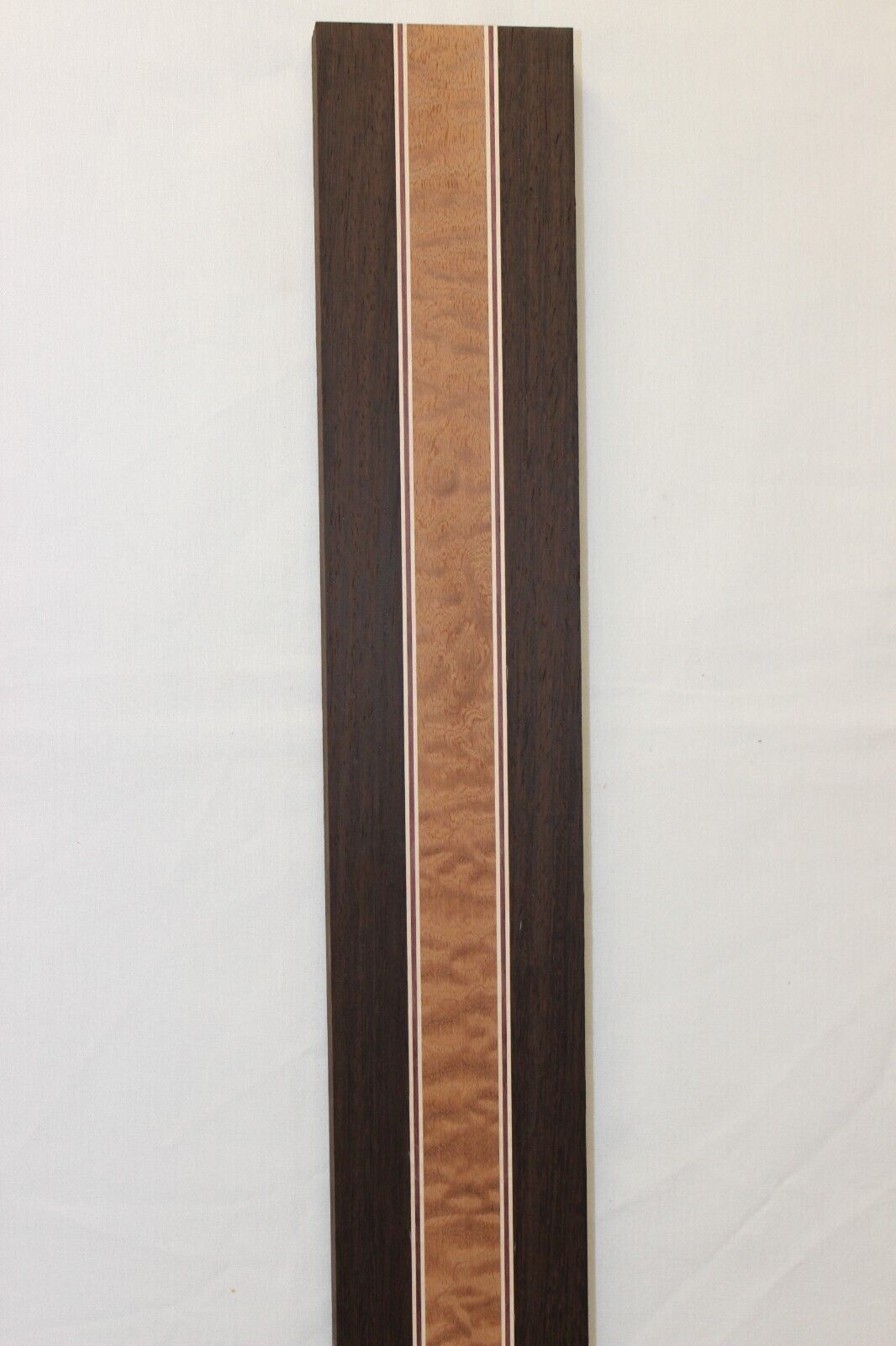 Quilted sapele, wenge, hard maple and purple-heart laminated guitar neck blank.