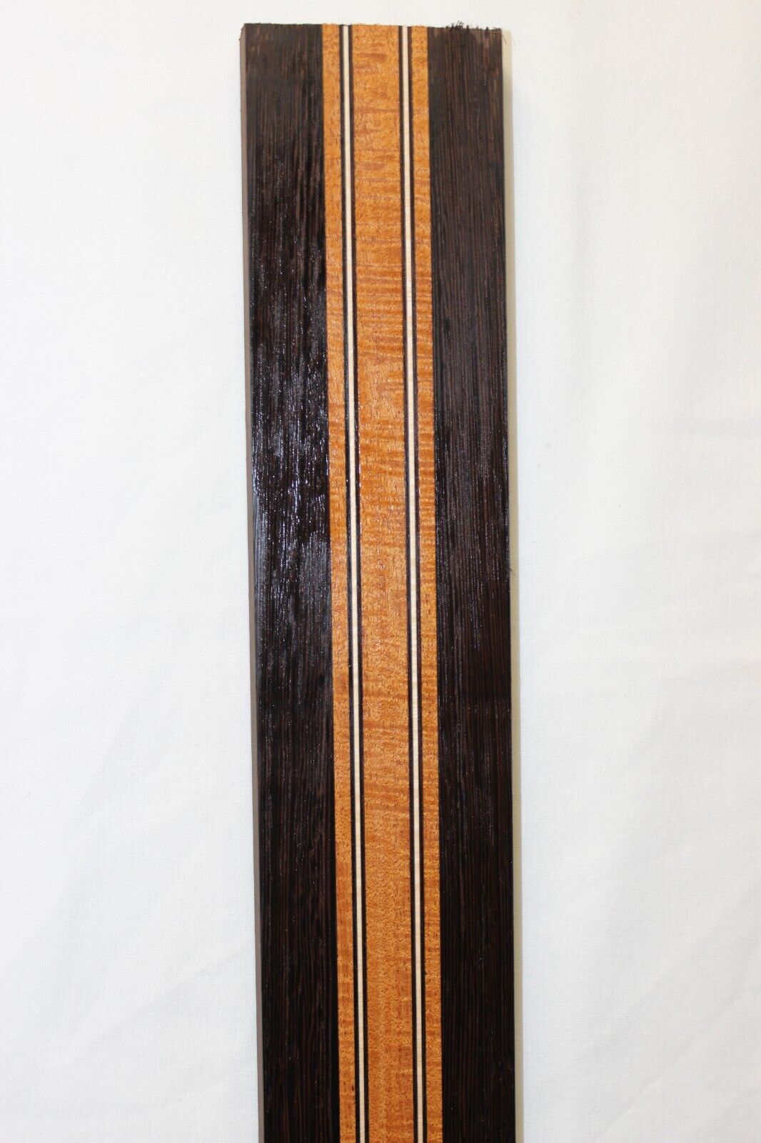Figured mahogany, wenge and hard maple laminated guitar neck blank.