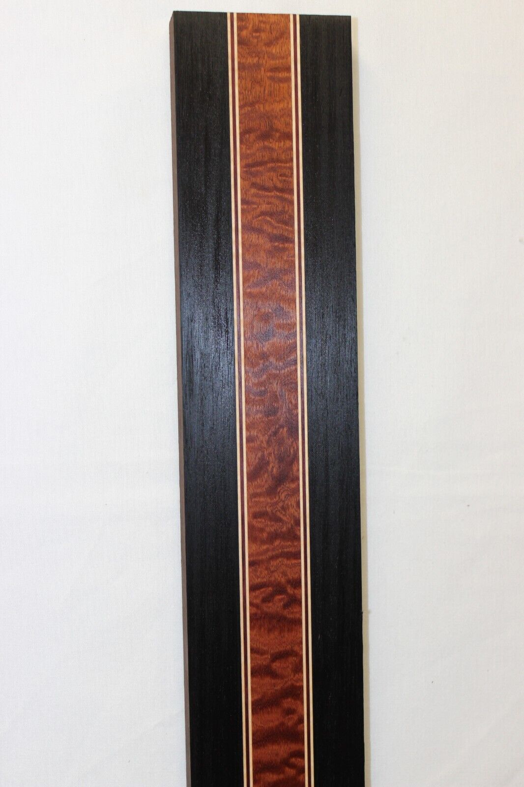 Quilted sapele, wenge, hard maple and purple-heart laminated guitar neck blank.