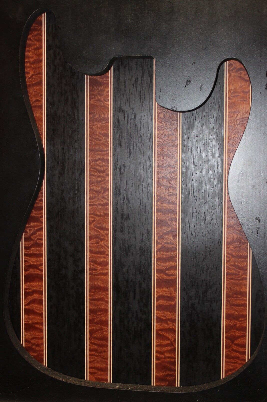 Quilted sapele, wenge, maple and purple-heart laminated electric guitar top.