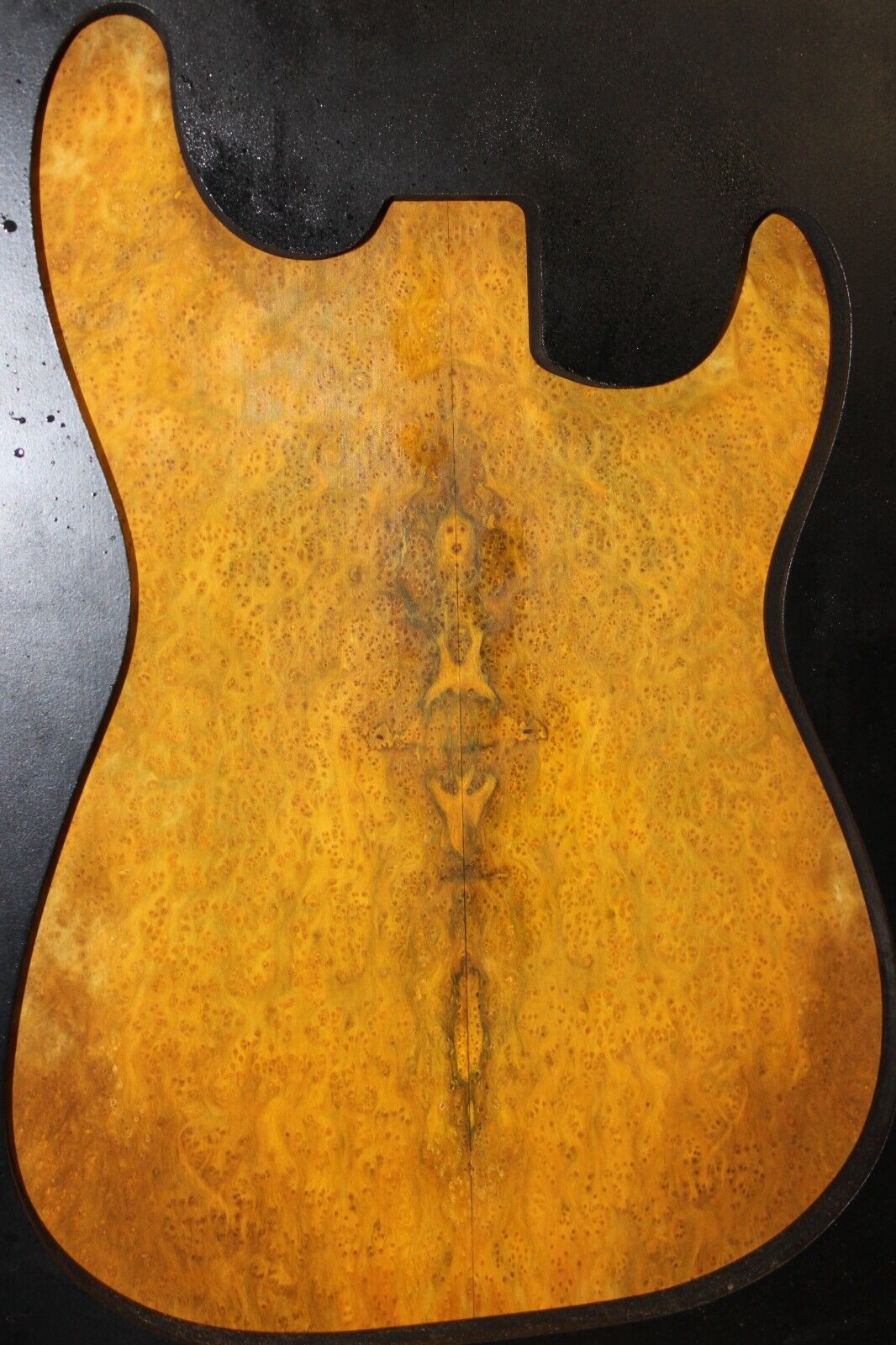 Golden Amboyna burl book matched guitar top.