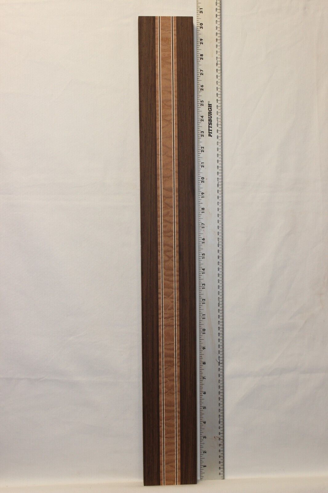Quilted sapele, wenge and flame maple laminated guitar neck blank.
