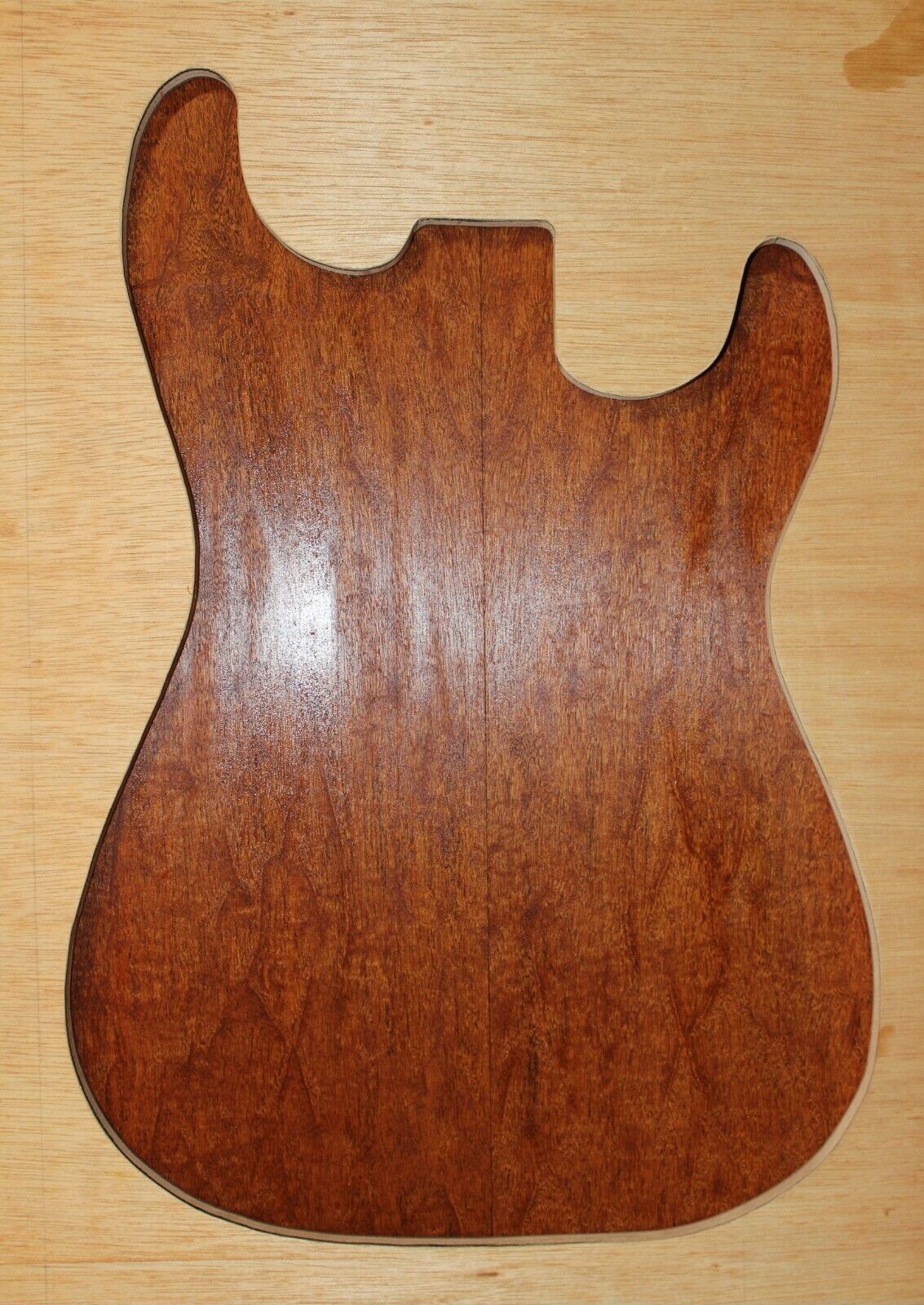 Figured genuine mahogany bookmatched electric guitar drop top.