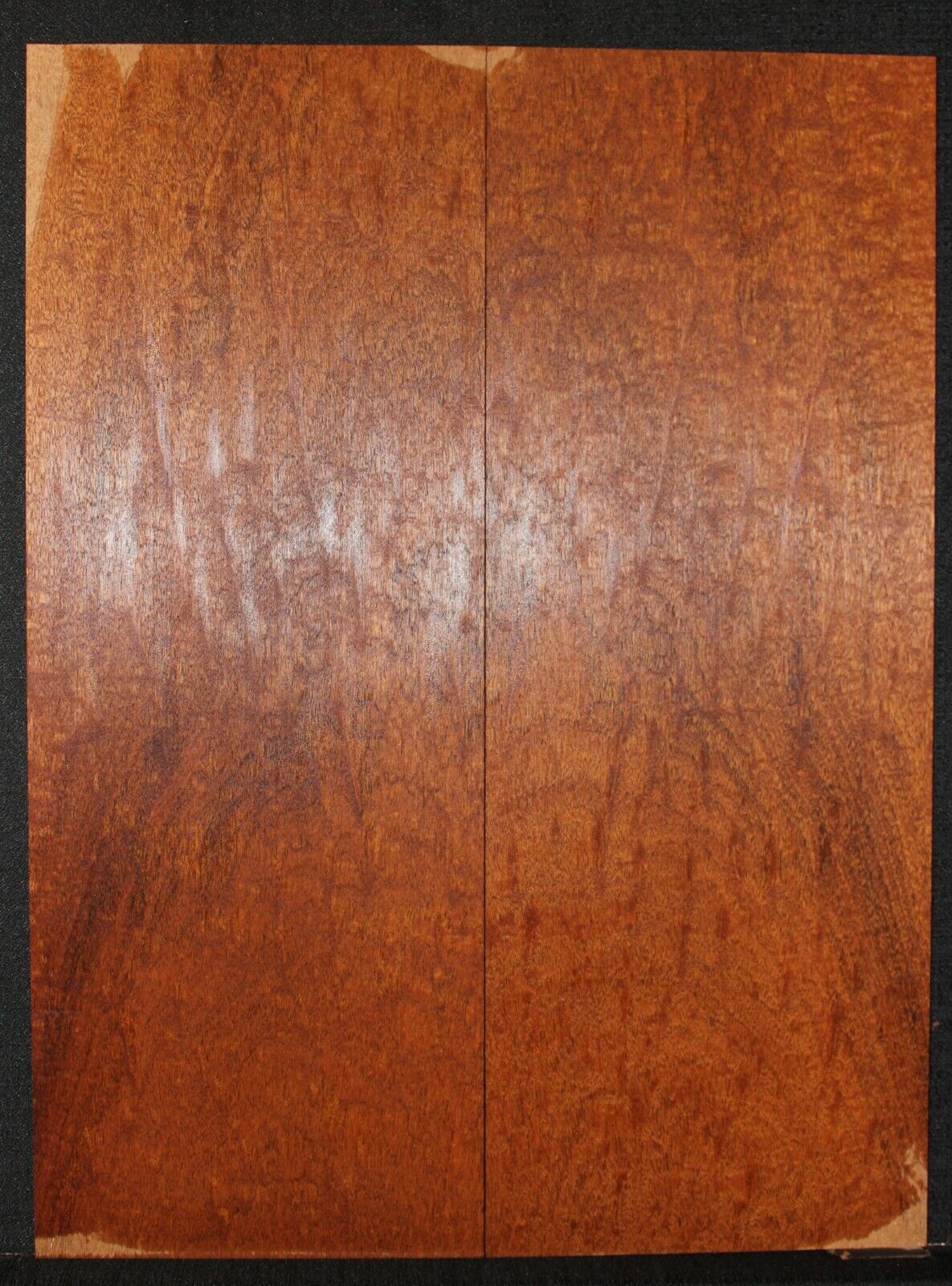 Figured genuine mahogany bookmatched electric guitar drop top.
