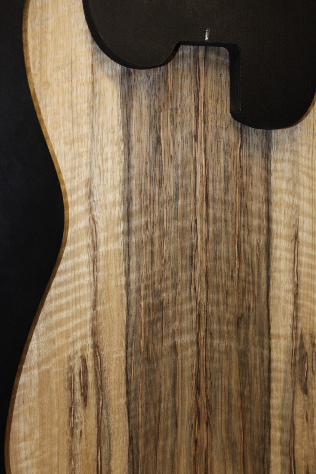 Curly black limba / korina figured book matched guitar top.