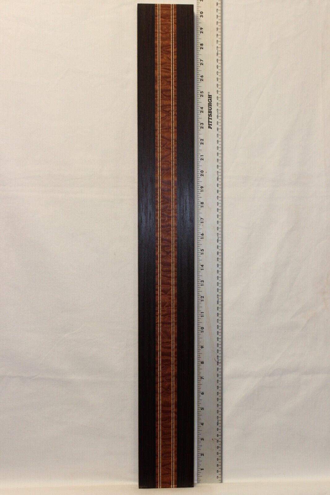 Quilted sapele, wenge and flame maple laminated guitar neck blank.