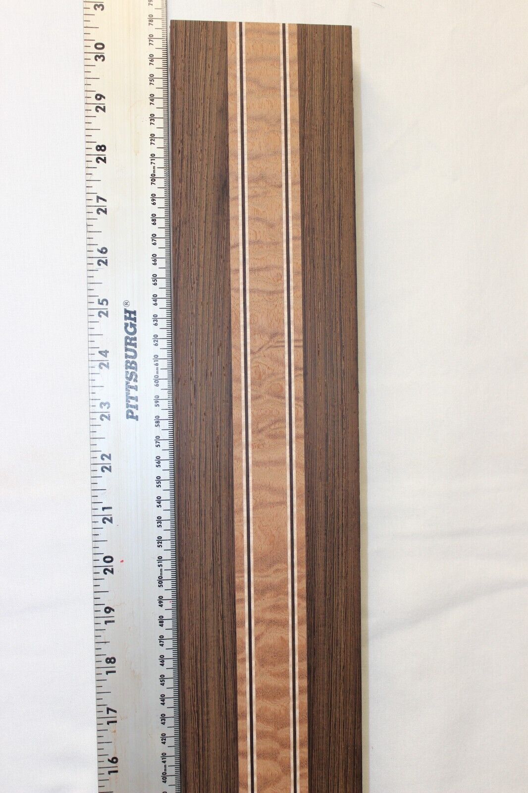 Quilted sapele, wenge and flame maple laminated guitar neck blank.