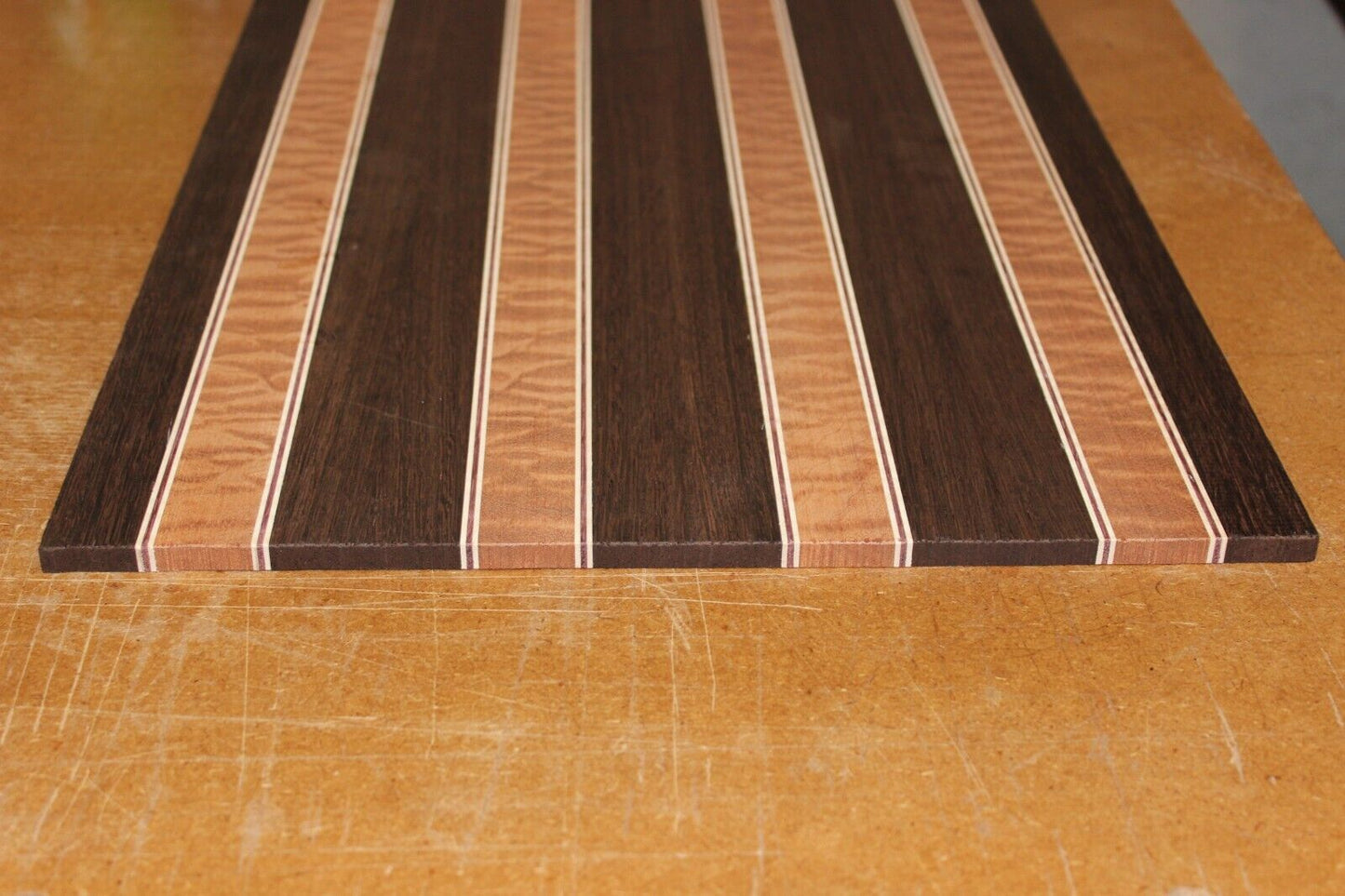 Quilted sapele, wenge, maple and purple-heart laminated electric guitar top.