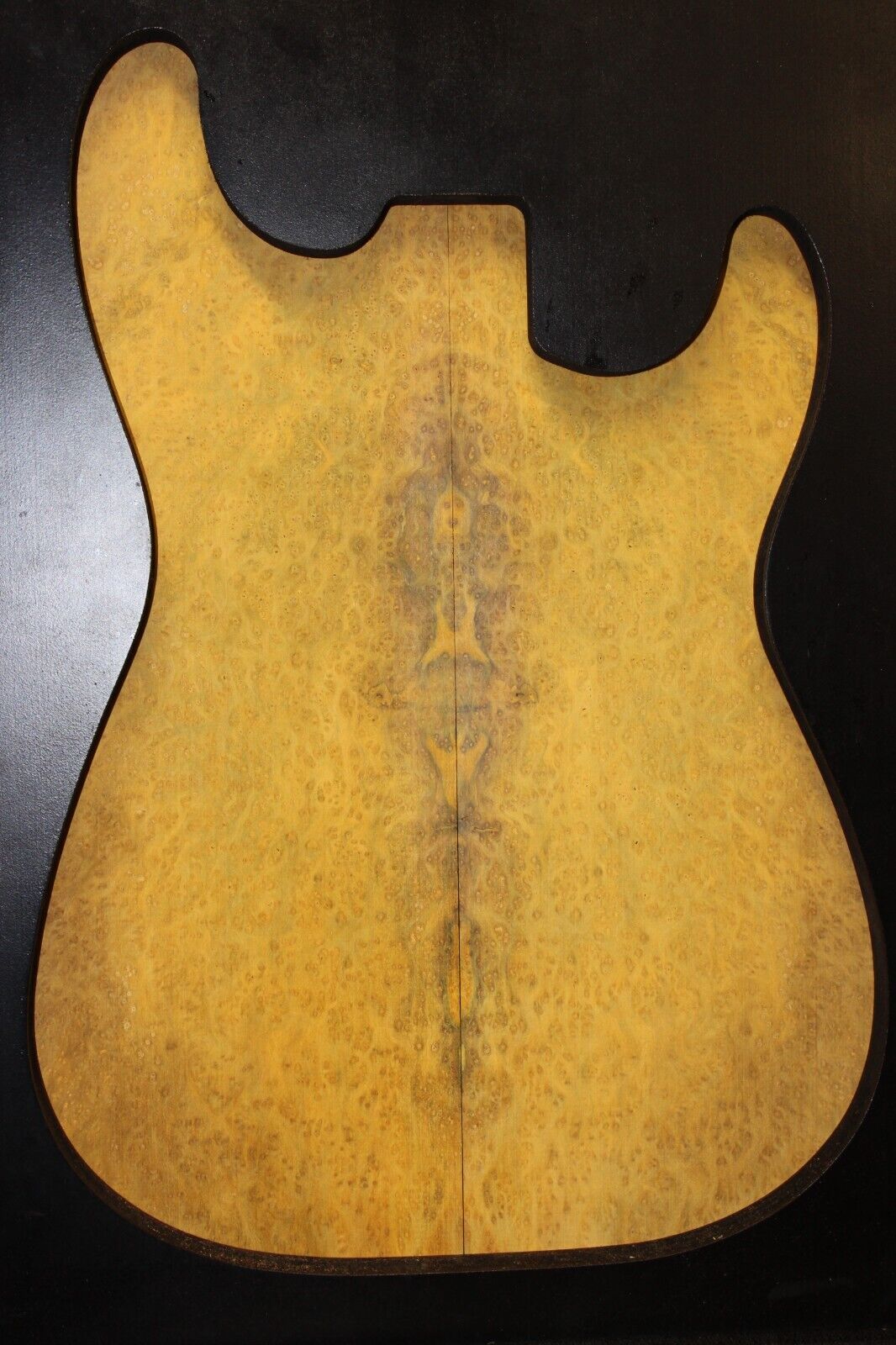 Golden Amboyna burl book matched guitar top.