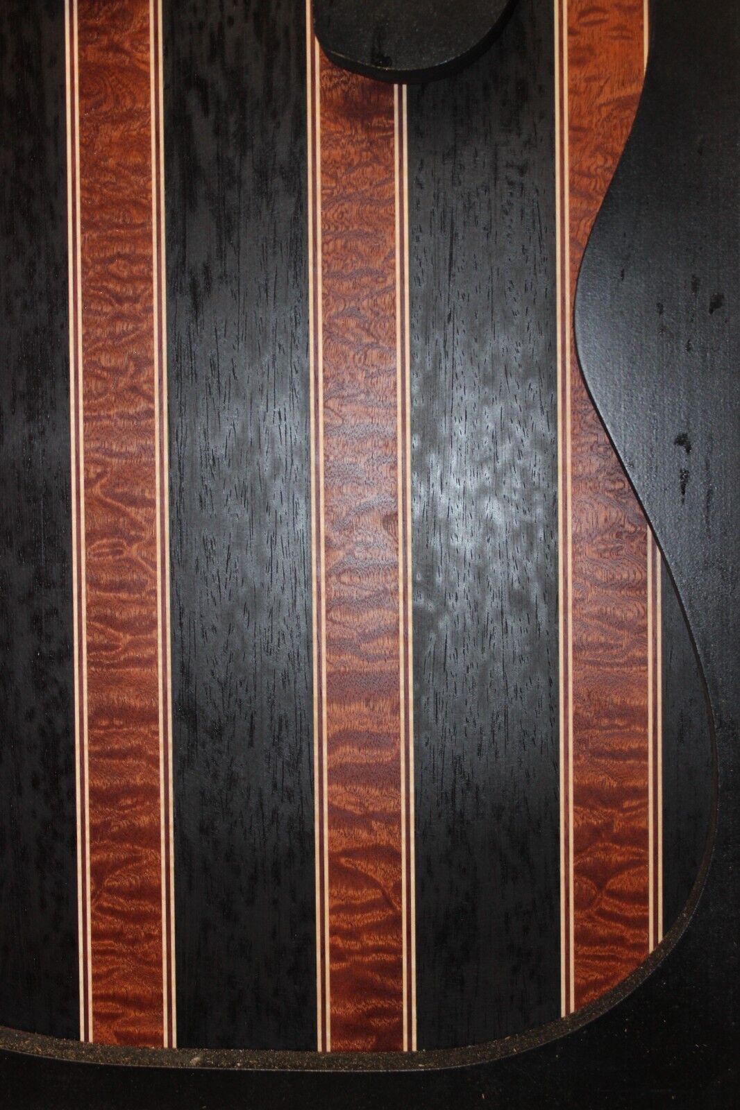 Quilted sapele, wenge, maple and purple-heart laminated electric guitar top.
