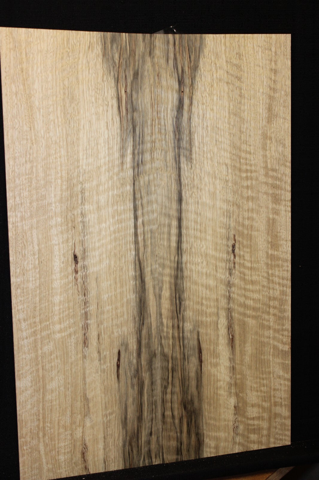 Curly black limba / korina figured book matched guitar top.