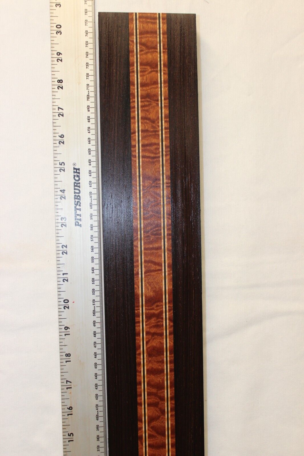 Quilted sapele, wenge and flame maple laminated guitar neck blank.