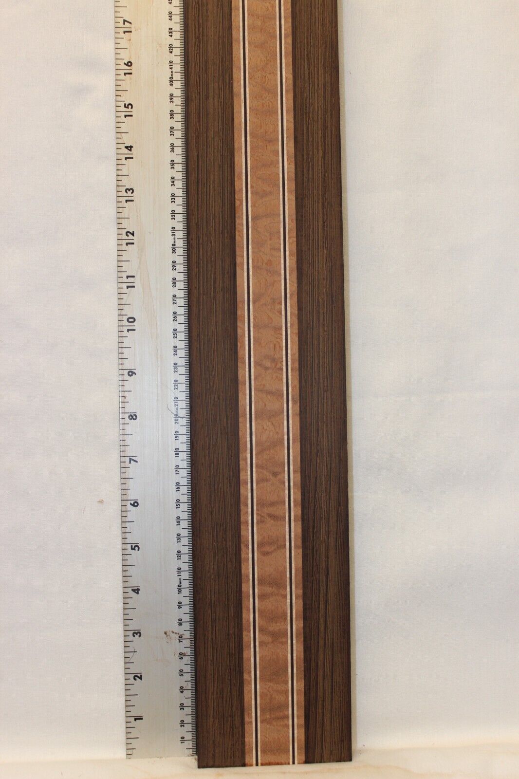 Quilted sapele, wenge and flame maple laminated guitar neck blank.