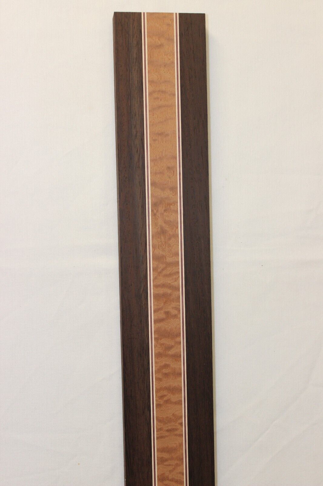 Quilted sapele, wenge, hard maple and purple-heart laminated guitar neck blank.