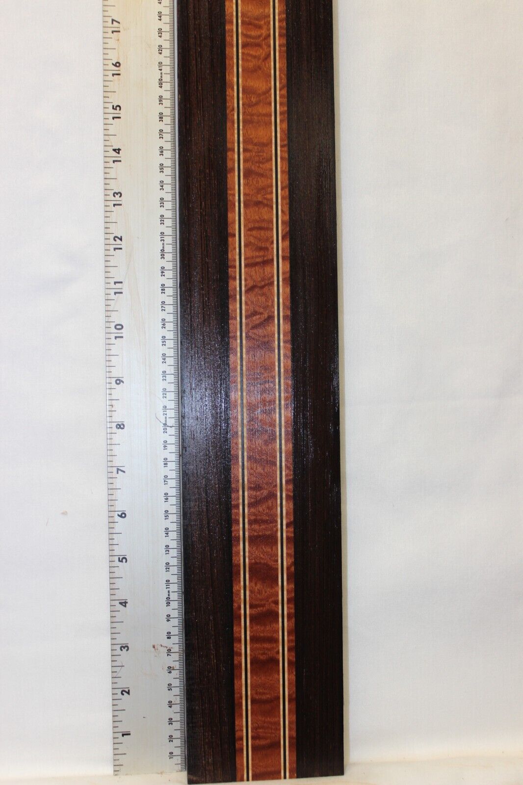 Quilted sapele, wenge and flame maple laminated guitar neck blank.