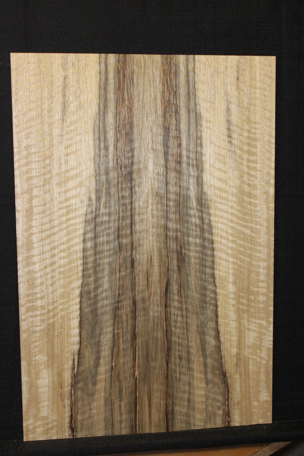 Curly black limba / korina figured book matched guitar top.