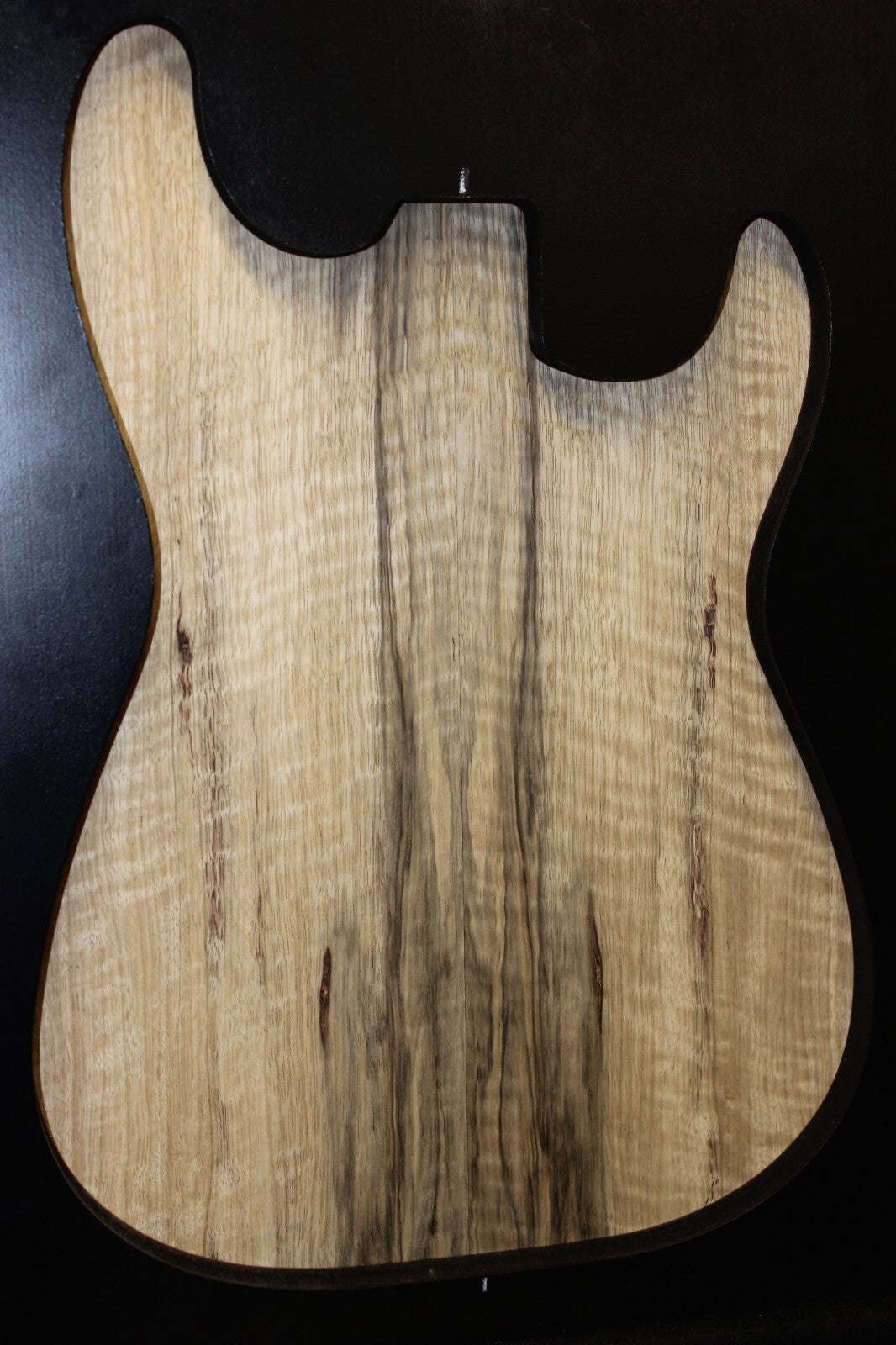 Curly black limba / korina figured book matched guitar top.