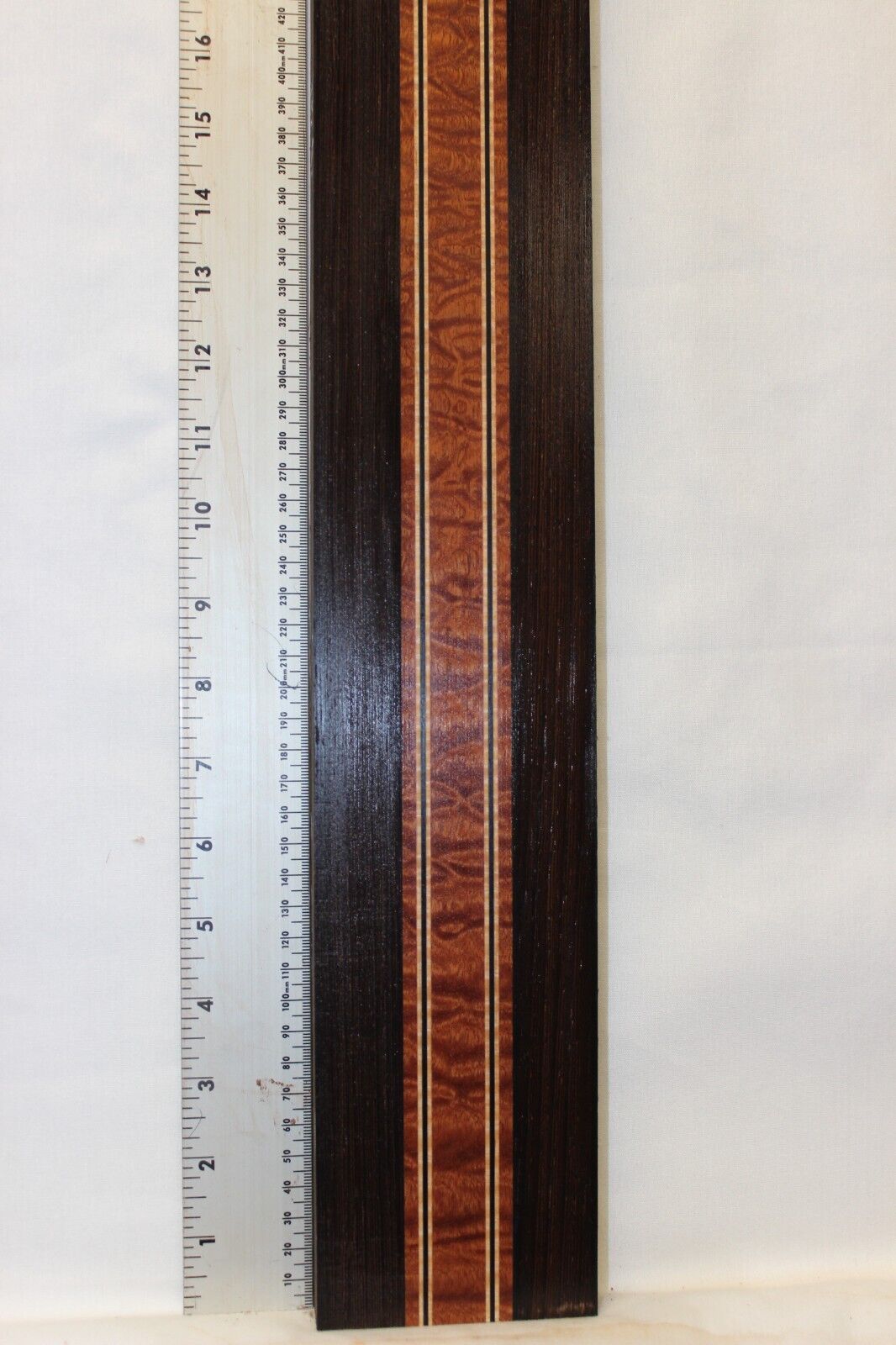 Quilted sapele, wenge and flame maple laminated guitar neck blank.