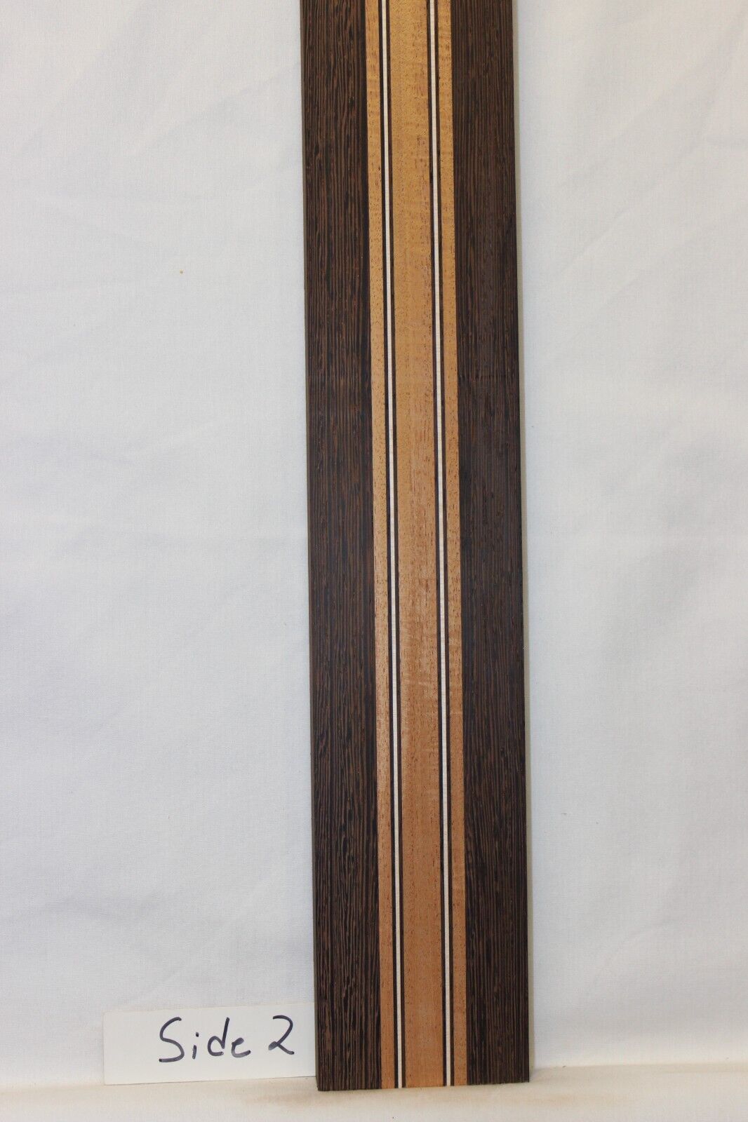 Figured mahogany, wenge and hard maple laminated guitar neck blank.