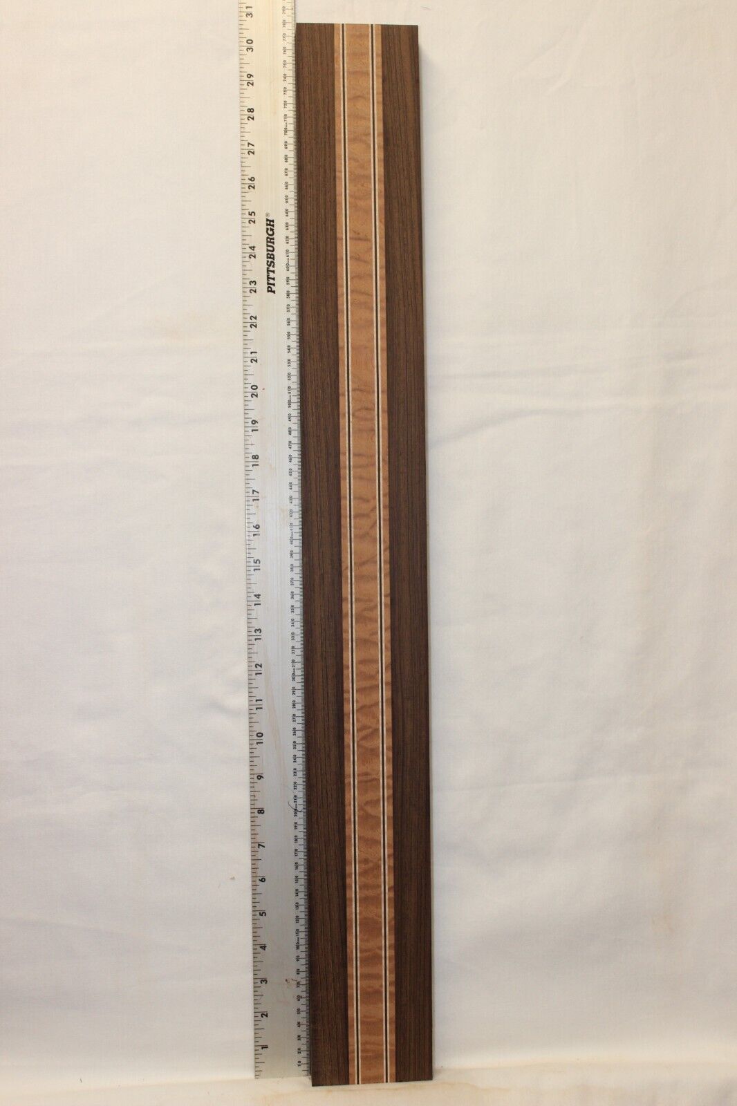 Quilted sapele, wenge and flame maple laminated guitar neck blank.
