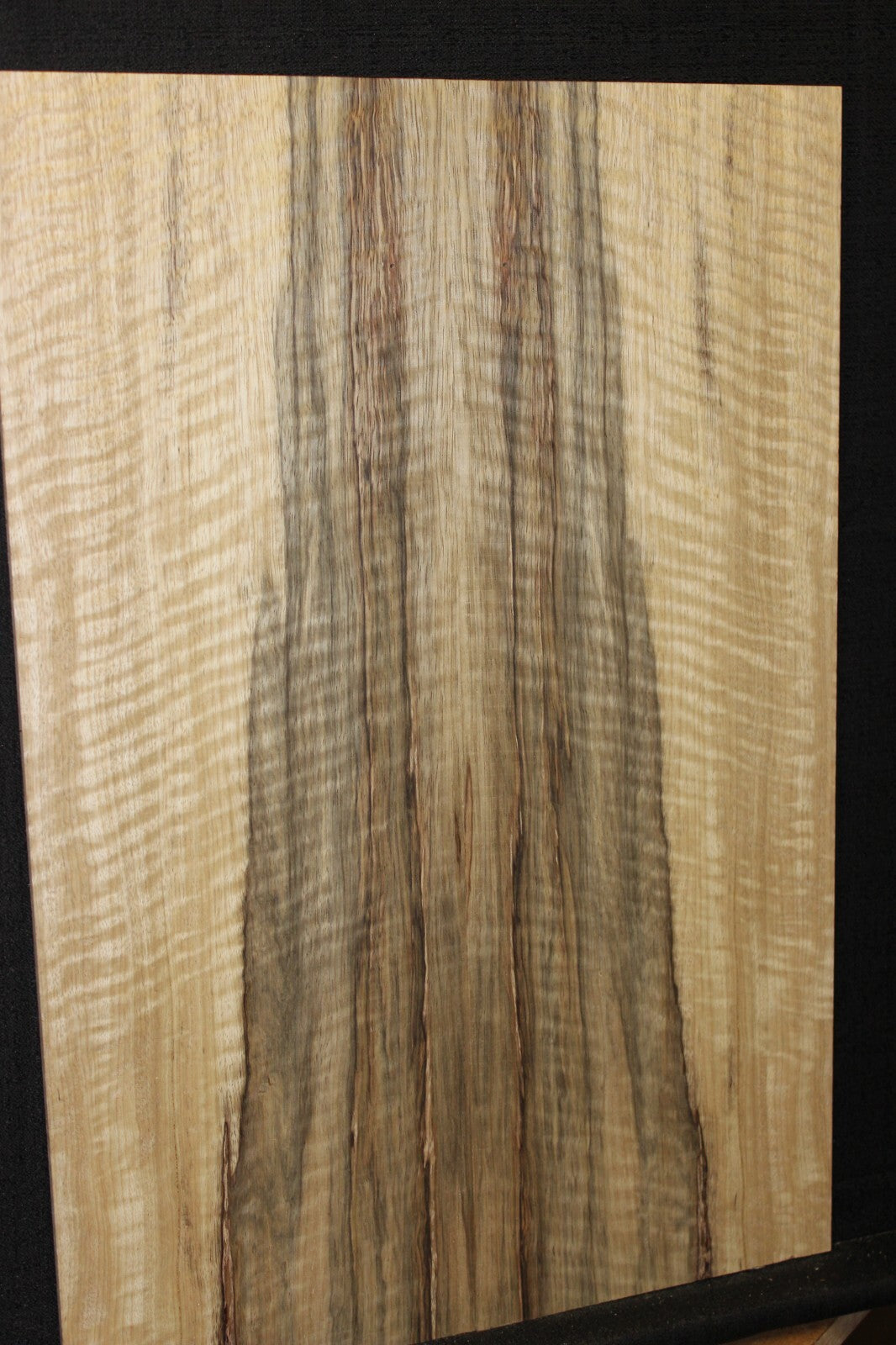 Curly black limba / korina figured book matched guitar top.