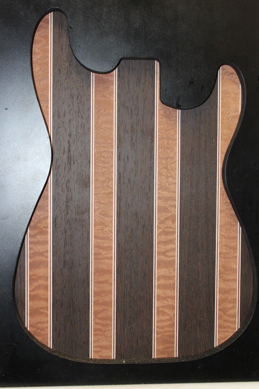 Quilted sapele, wenge, maple and purple-heart laminated electric guitar top.