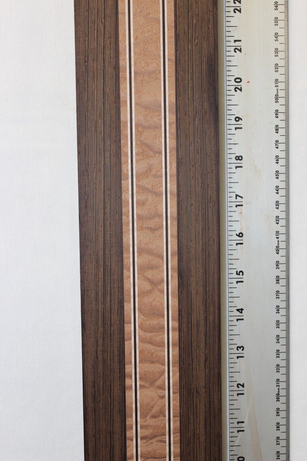 Quilted sapele, wenge and flame maple laminated guitar neck blank.