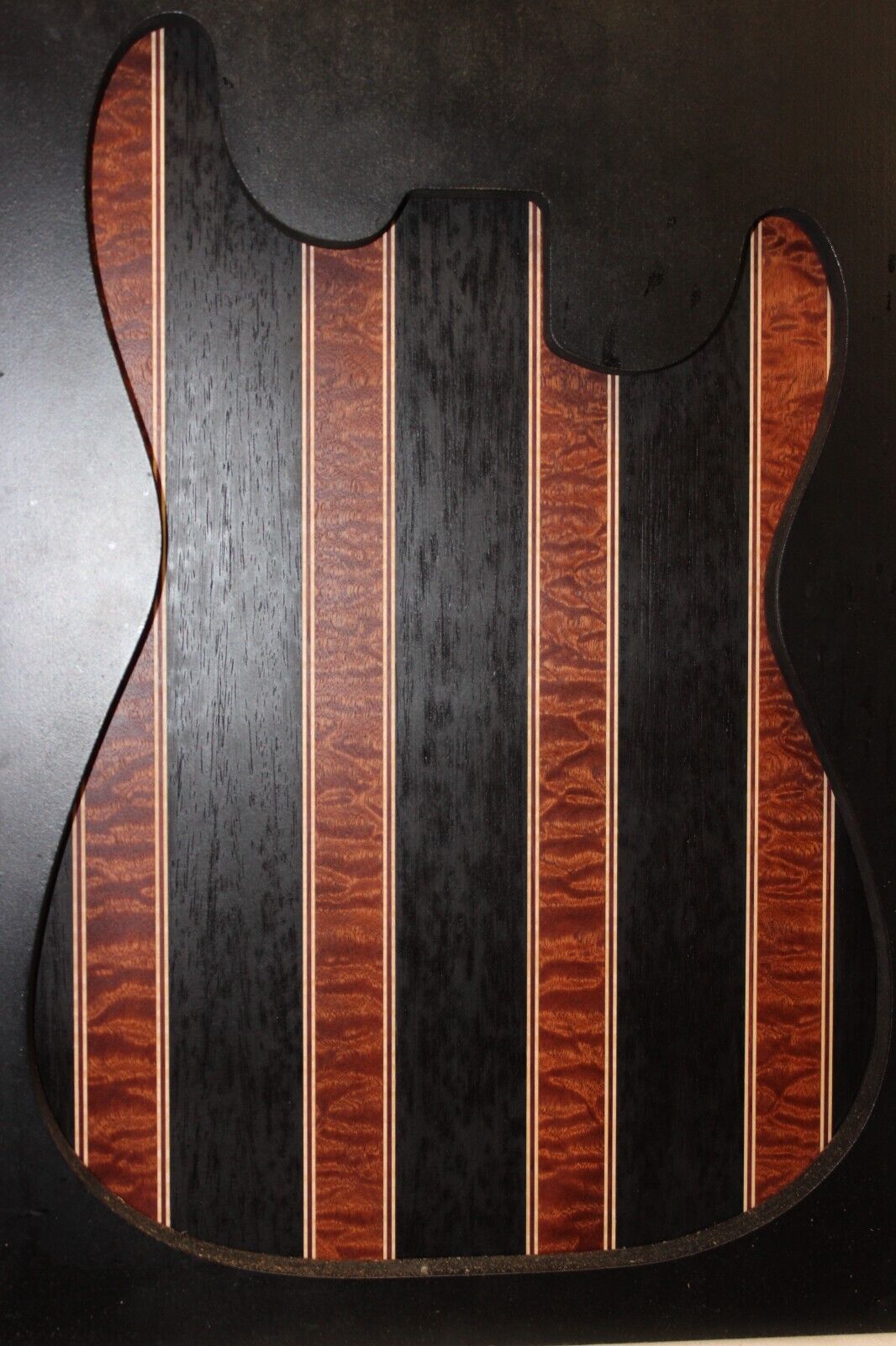 Quilted sapele, wenge, maple and purple-heart laminated electric guitar top.