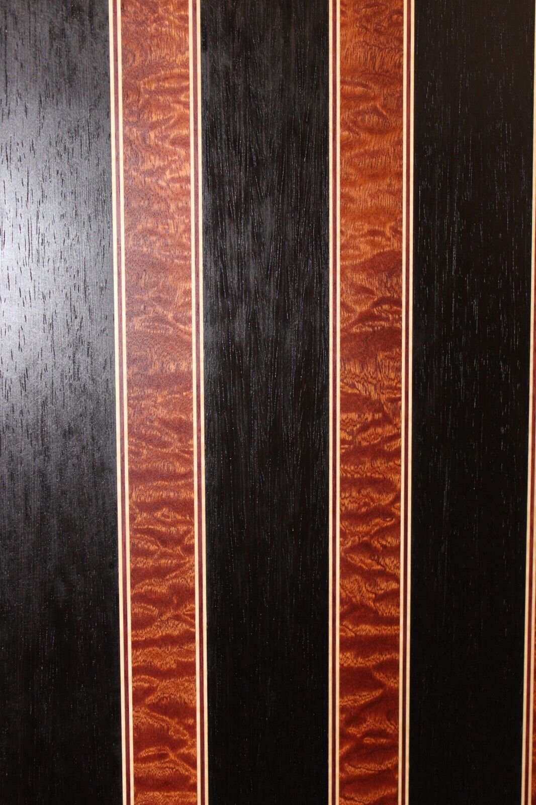 Quilted sapele, wenge, maple and purple-heart laminated electric guitar top.