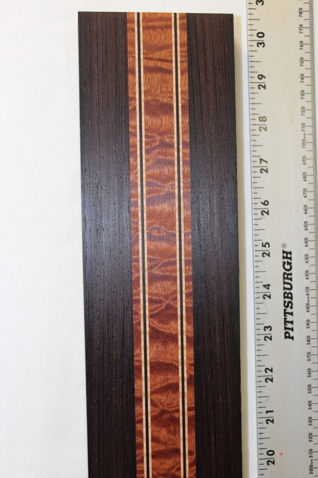 Quilted sapele, wenge and flame maple laminated guitar neck blank.