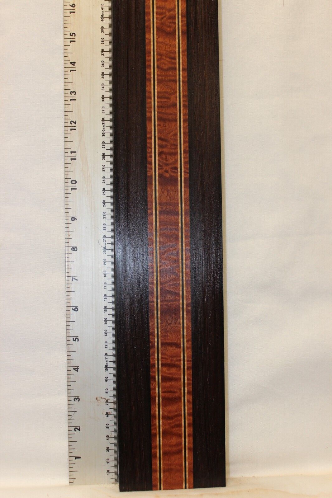Quilted sapele, wenge and flame maple laminated guitar neck blank.