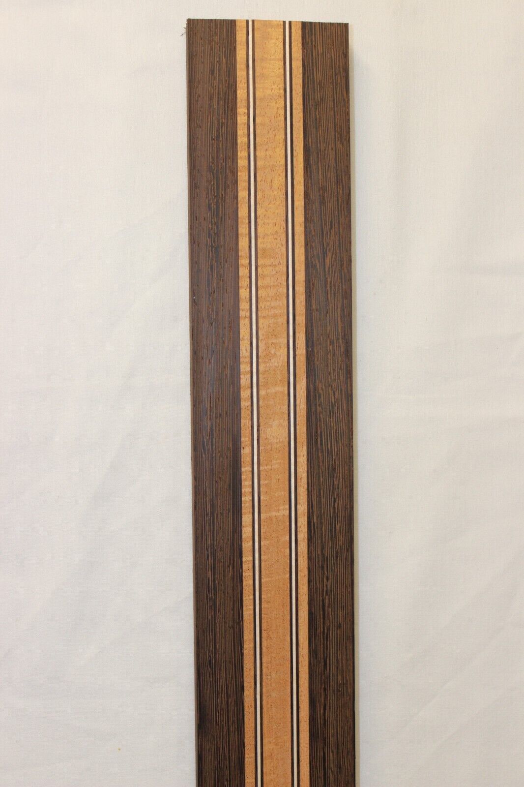 Figured mahogany, wenge and hard maple laminated guitar neck blank.