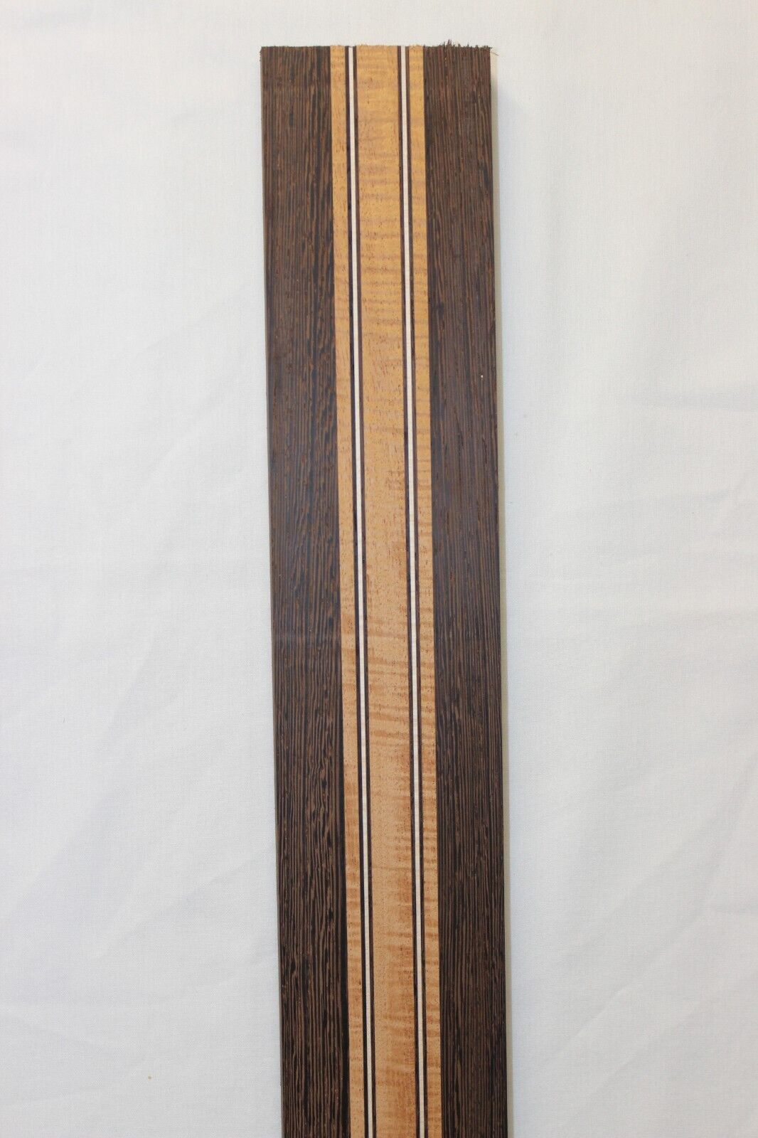 Figured mahogany, wenge and hard maple laminated guitar neck blank.