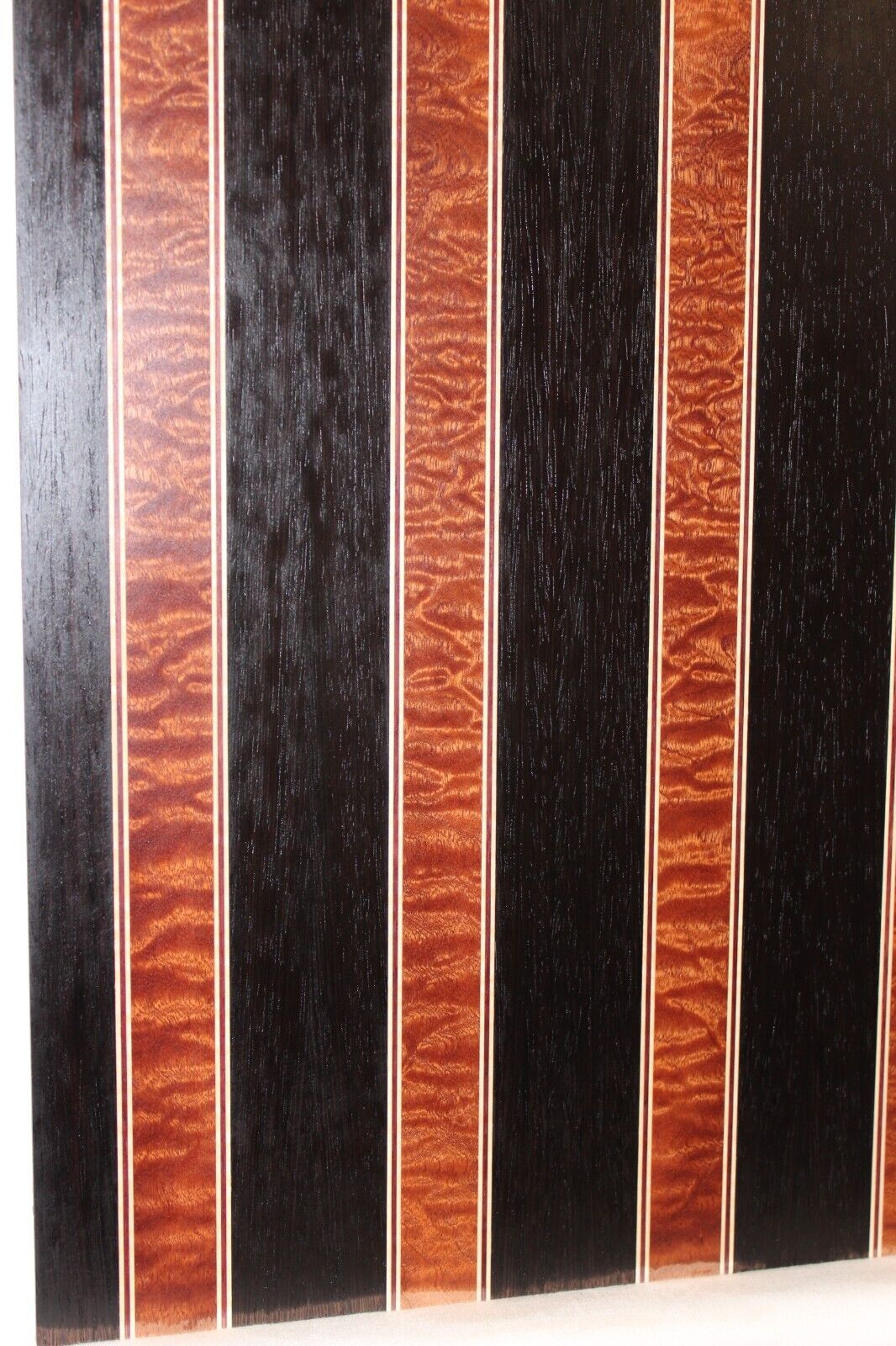 Quilted sapele, wenge, maple and purple-heart laminated electric guitar top.